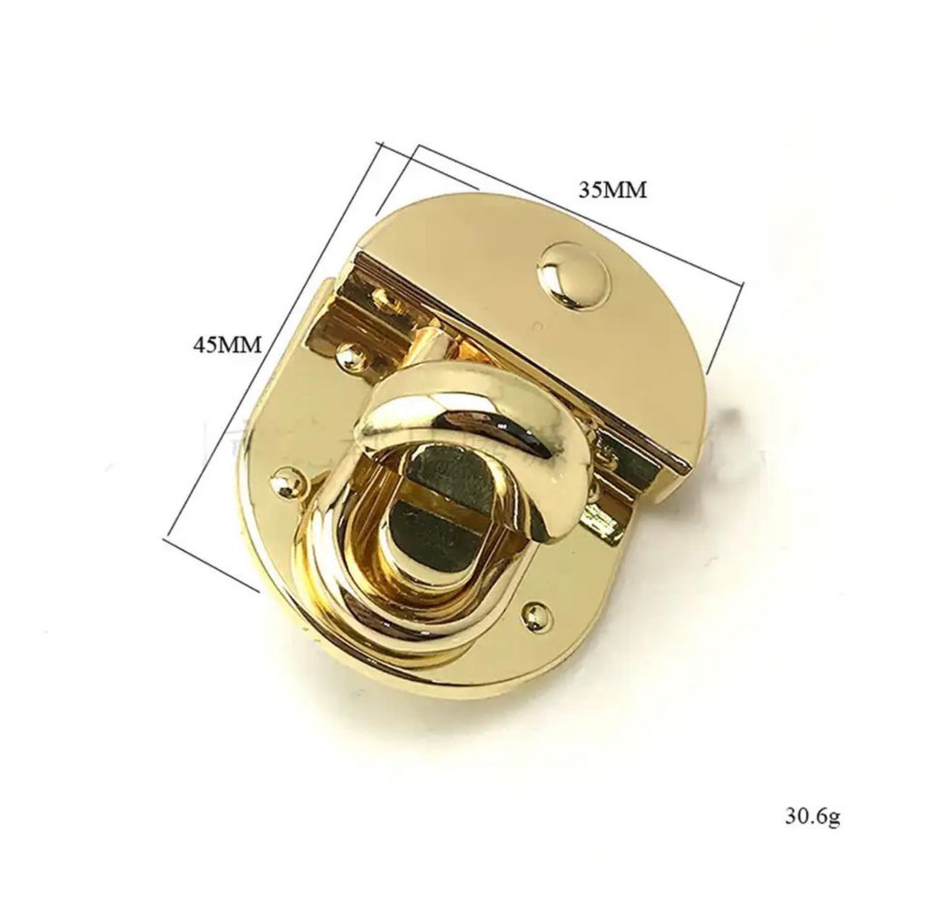 Gold-toned metal latch or clasp hardware shown on a white background with overlaid dimension lines and text indicating 35mm width, 45mm height, and 30.6g weight.