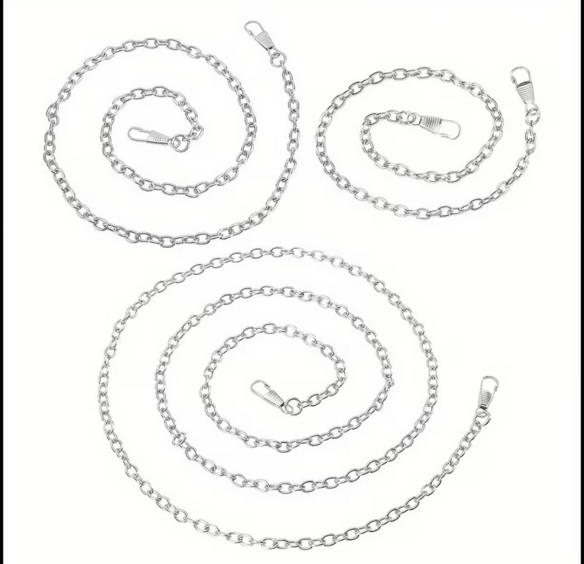Three silver metal link chains with lobster clasp ends, arranged in loose spiral shapes on a plain white background.