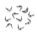 Ten small polished silver metal lobster clasp findings scattered on a clean white background.