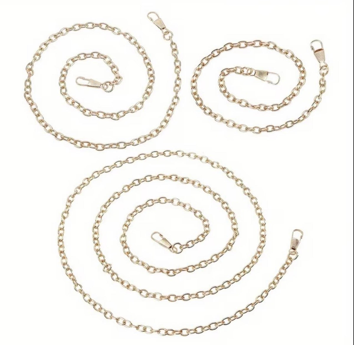 Three gold-colored metal chain straps with lobster clasp ends, arranged in loose spiral shapes on a plain white background.