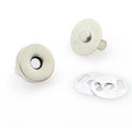 Two silver-toned metal snap buttons with flat backing discs, shown on a plain white background.