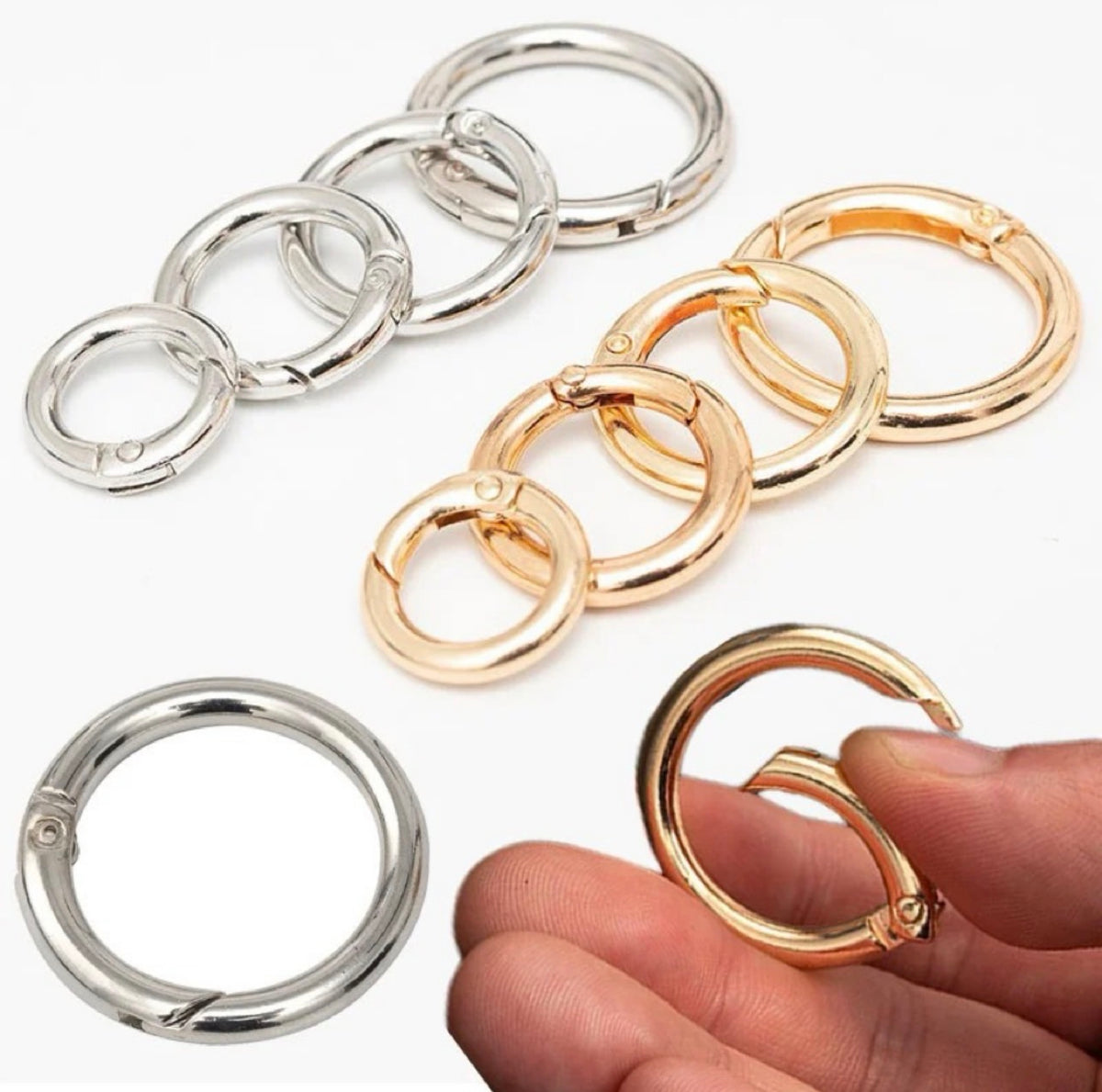 Two pairs of interlocking ring clamps shown on a white background, one in polished silver-tone metal and one in polished gold-tone metal. A hand is holding a gold-tone clamp in the lower right corner to demonstrate scale.