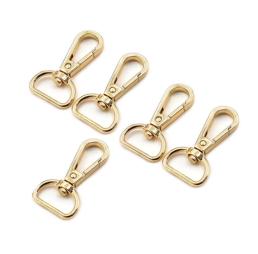 Five gold-tone metal swivel snap hooks arranged on a plain white background.