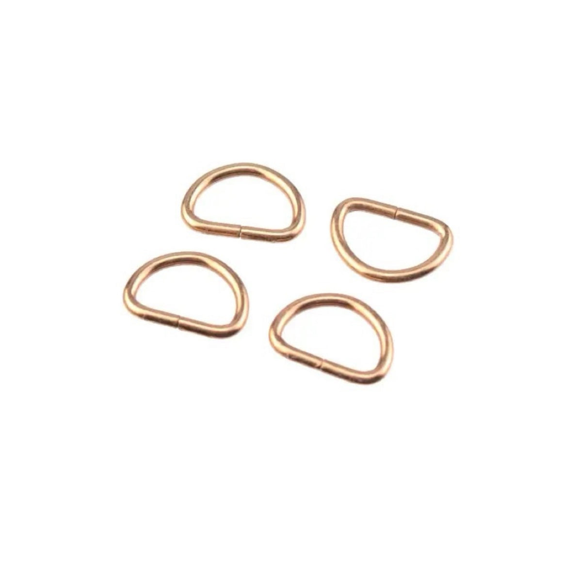 Four small rose gold metal loop clasps arranged on a plain white background.