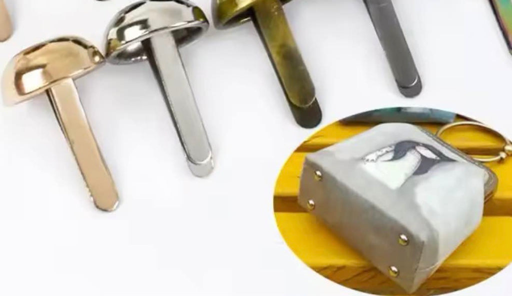 Mushroom-shaped metal wall hooks in various finishes, including gold, silver, bronze, and dark gray, with an inset showing a gray pouch hanging from one of the hooks.